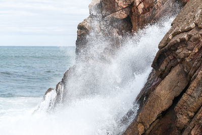 Sea waves splashing on rocks