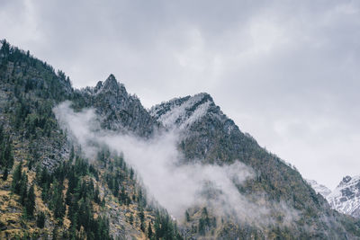 Low angle view of majestic mountains against sky