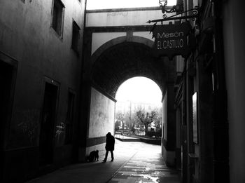 People walking on street amidst buildings in city