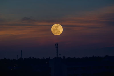 Scenic view of silhouette moon against romantic sky at sunset