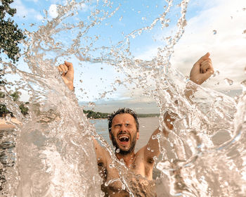 Portrait of young woman swimming in sea