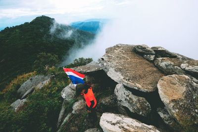 Scenic view of waterfall against mountain