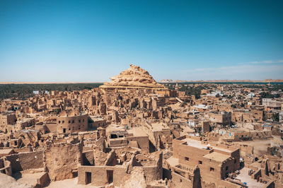 High angle view of townscape against clear blue sky