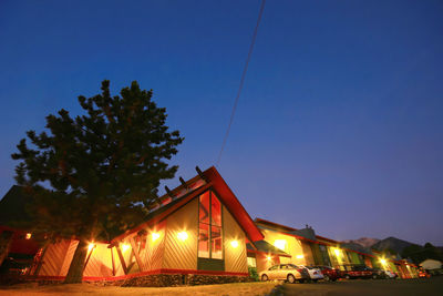 Illuminated built structure against clear blue sky at night