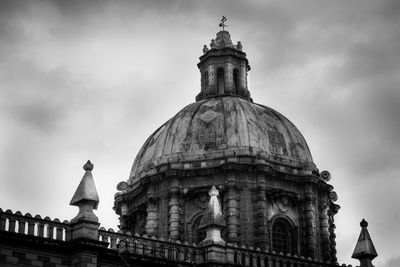 Low angle view of building against cloudy sky