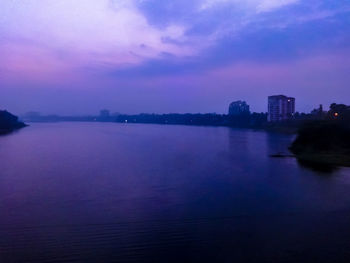 Scenic view of sea against cloudy sky at dusk