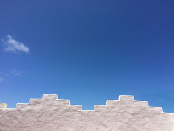 Low angle view of buildings against blue sky