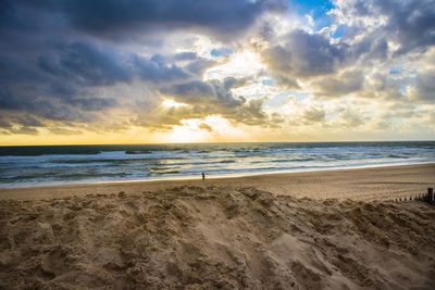 Scenic view of beach against sky during sunset