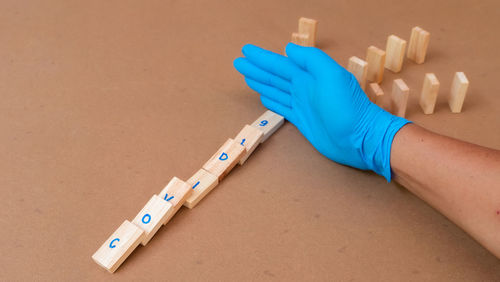 High angle view of hand on blue table