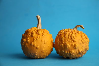 Close-up of fruits against blue background