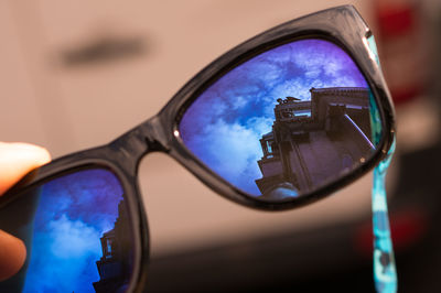 Reflection of historic building on sunglasses