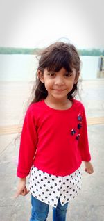 Portrait of smiling girl standing outdoors