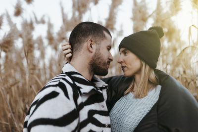 Couple looking each other in countryside at sunset. girlfriend and boyfriend.