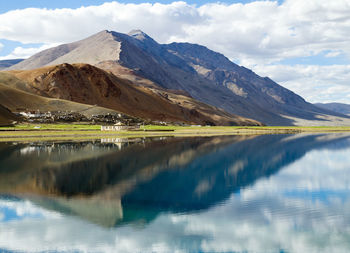 Scenic view of lake and mountains against sky