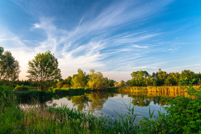 Scenic view of lake against sky at sunset