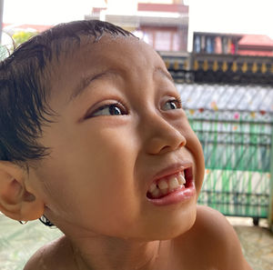 Close-up portrait of smiling girl looking away