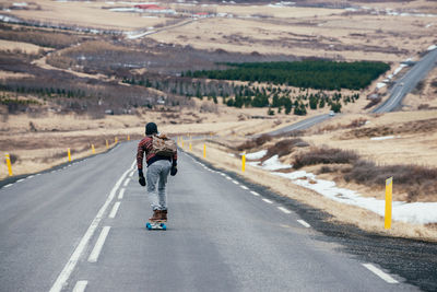 Man skateboarding on highway