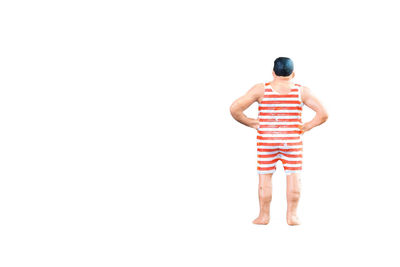 Rear view of shirtless man standing against white background