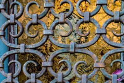 Full frame shot of decorative ironwork grill protecting religious shrine