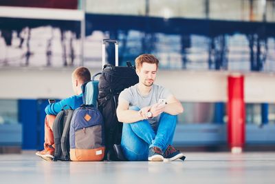 Friends with luggage waiting at airport