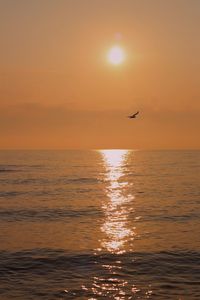 Scenic view of sea against orange sky