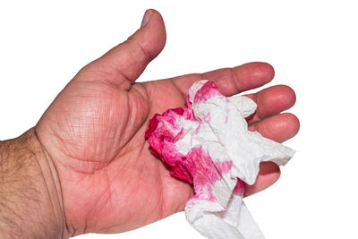 Cropped image of man holding crumpled tissue paper against white background