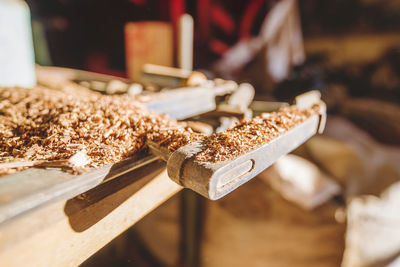 Close-up of wood shavings on table at workshop