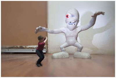 Full length of happy boy with arms raised