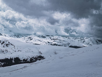 Scenic view of snow covered mountains against sky