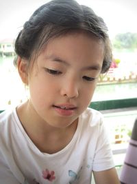 Close-up portrait of a girl looking down