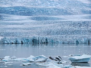 Scenic view of glacier in front of a lake