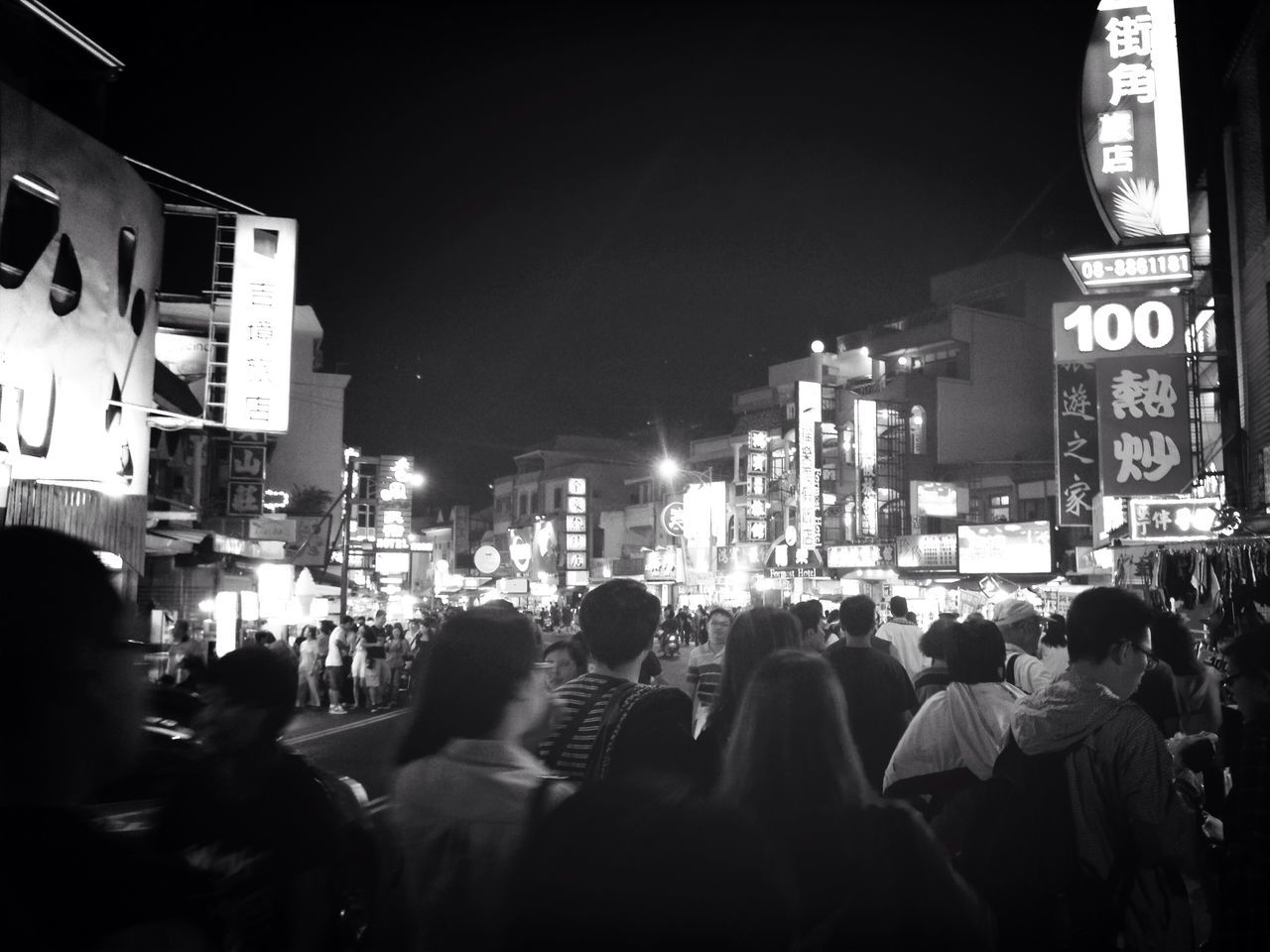 large group of people, night, illuminated, men, architecture, building exterior, built structure, street, crowd, person, lifestyles, city, text, city life, communication, leisure activity, city street, non-western script, walking