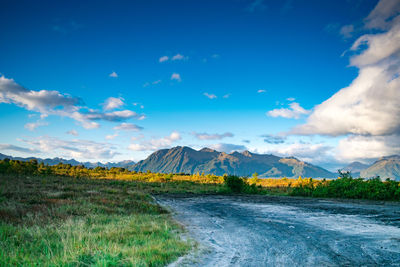 Scenic view of landscape against blue sky