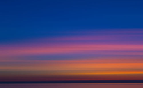 Scenic view of sea against romantic sky at sunset