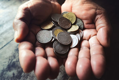 Close-up of hand holding coins