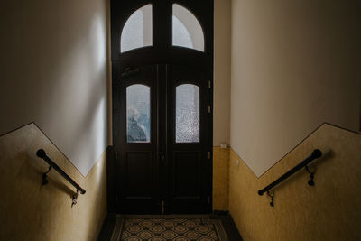 Hallway of old apartment building with tiles on floor