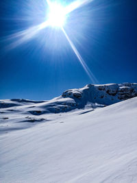 Scenic view of snow against clear blue sky