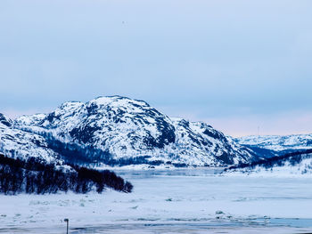 Scenic view of snowcapped mountains against clear sky