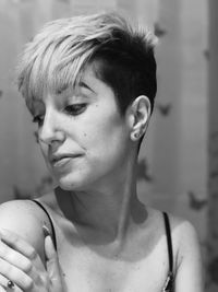 Close-up of thoughtful woman with short hair looking away