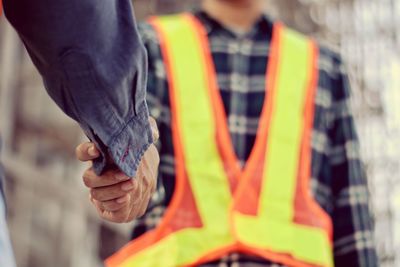 Close-up of man working against blurred background