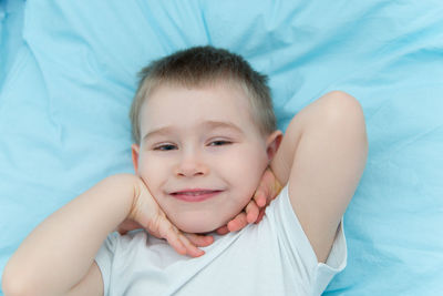 Portrait of cute girl lying on bed