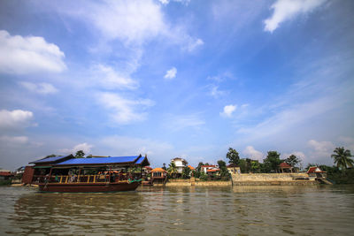 Scenic view of river by building against sky