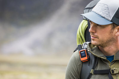 Portrait of backpacker hiking with gps tracker (tracking) on.