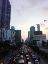 View of city street against cloudy sky