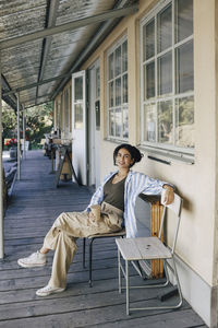 Portrait of smiling female entrepreneur sitting on chair