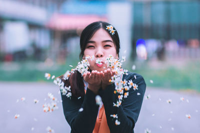 Portrait of young woman eating outdoors