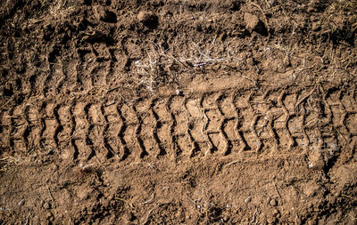 High angle view of tire tracks on sand