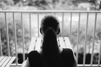 Rear view of woman sitting outdoors