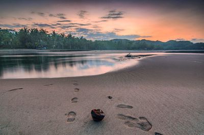 Scenic view of lake against sky during sunset