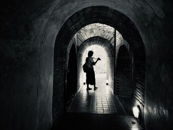 Woman walking in tunnel